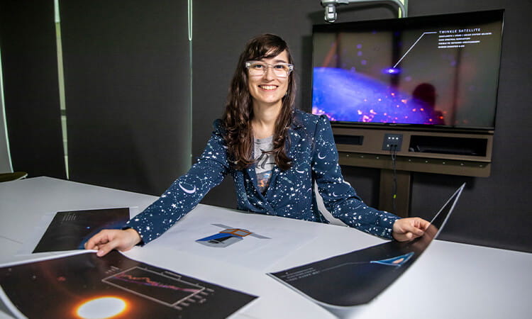 An astronomer holding photos from space. 