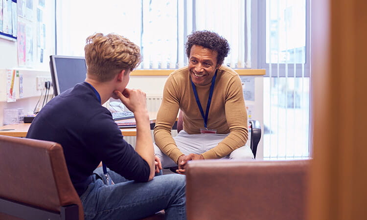 Counsellor talking to a younger man.